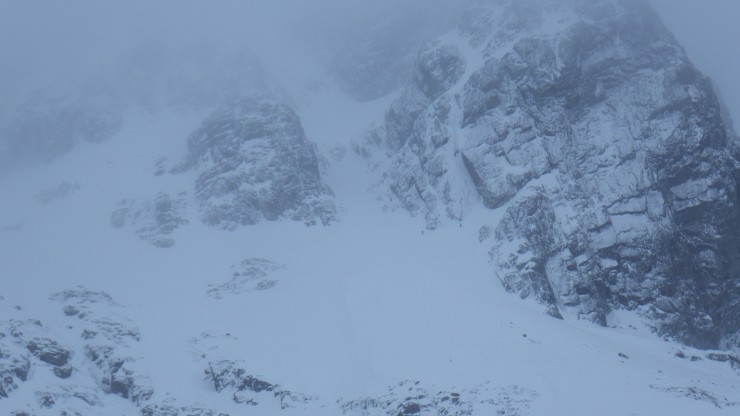 The bottom of Number 5 gully with two climbers heading over to the base of the curtain. 
