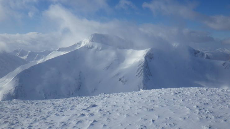 View from Aonach Mor plateau to Carn Mor Dearg and Ben Nevis behind.