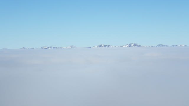 Higher summits were visible above the cloud layer.